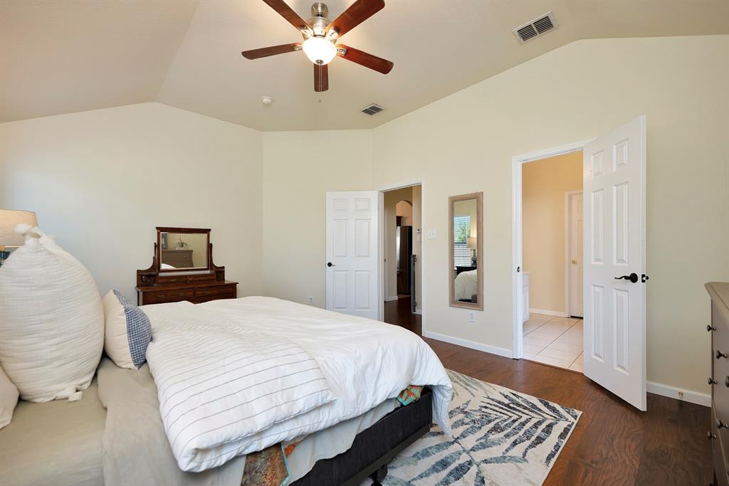 1333 Missionary Ridge Trail Fort Worth, TX 76131 - Photo 17 of 31 a bedroom with a bed and wooden floor