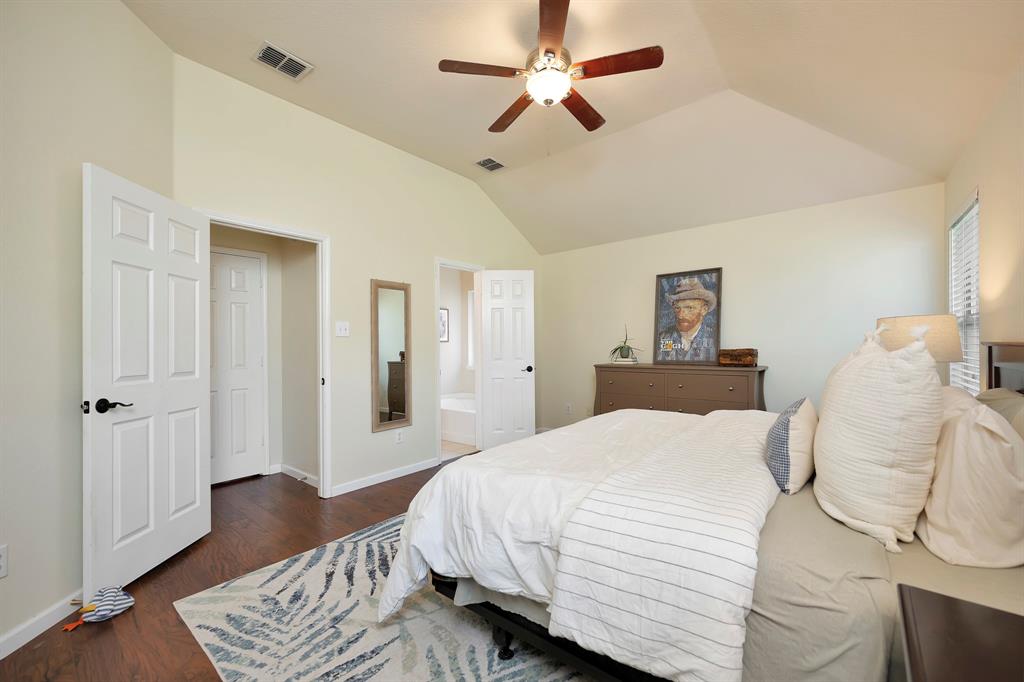 1333 Missionary Ridge Trail Fort Worth, TX 76131 - Photo 19 of 31 a bedroom with a bed ceiling fan and a wooden floor