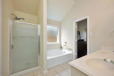 a bathroom with a tub and shower