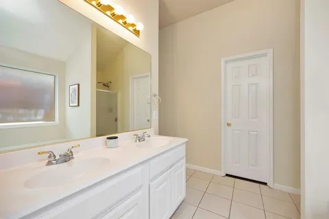 a bathroom with a sink a mirror and a shower