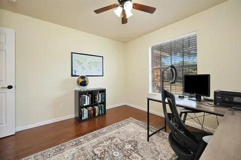 a workspace with furniture hardwood and a wooden floor