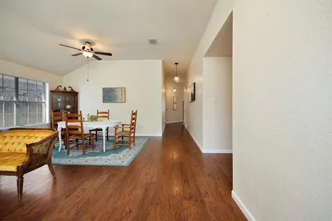 a view of a dining room with furniture and wooden floor