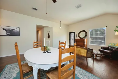 a view of a dining room with furniture window and wooden floor