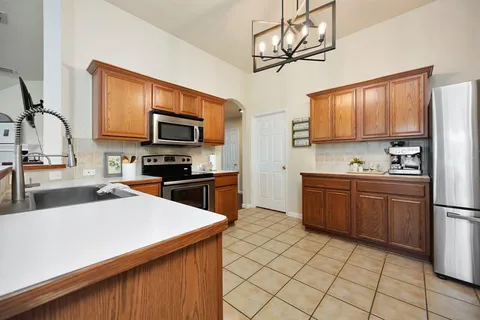 a kitchen with a sink a microwave and cabinets