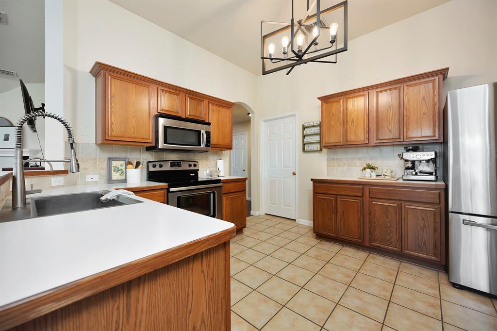 1333 Missionary Ridge Trail Fort Worth, TX 76131 - Photo 10 of 31 a kitchen with a sink a microwave and cabinets