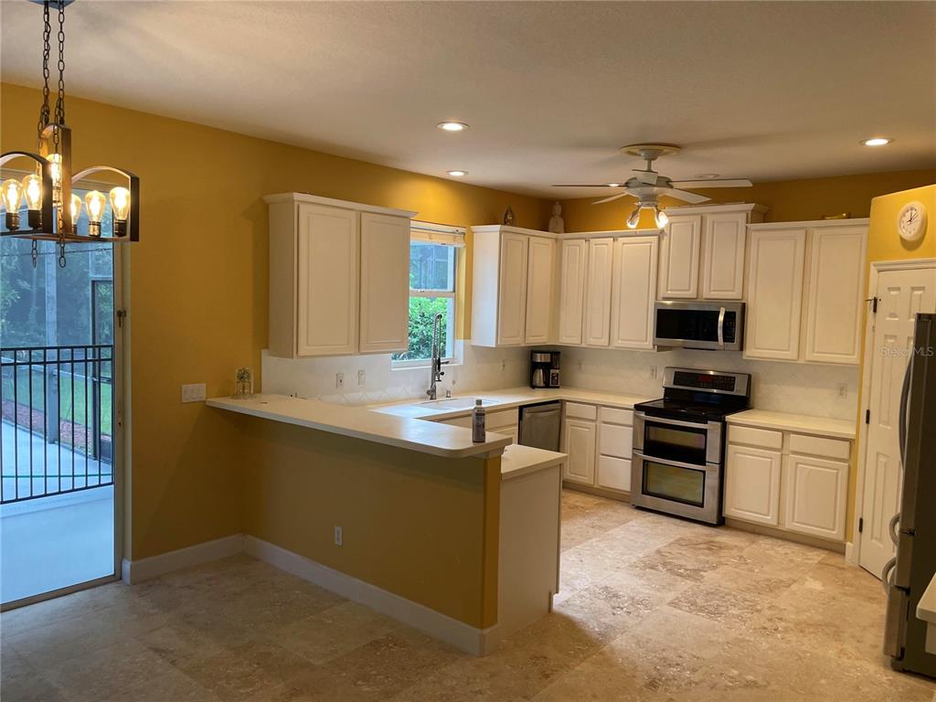 759 Fordingbridge Way Osprey, FL 34229 - Photo 33 of 51 a kitchen with stainless steel appliances granite countertop a sink stove and refrigerator