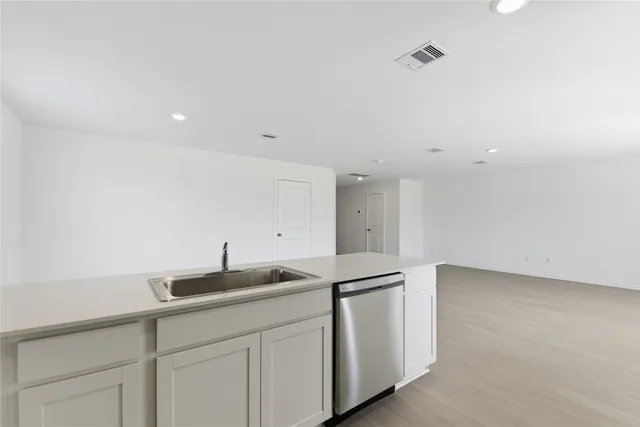 a kitchen with a sink and cabinets