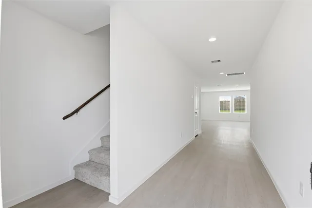 a view of a hallway with staircase