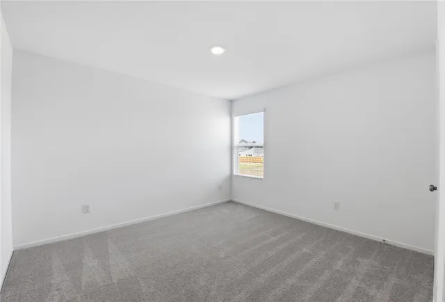 a view of an empty room and a window