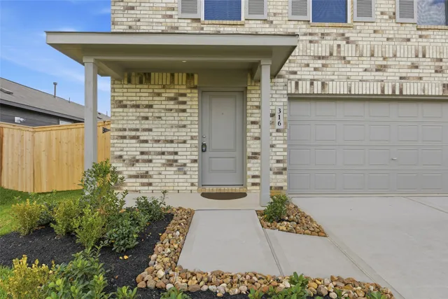 a front view of a building with potted plants