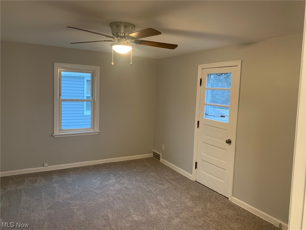 1456 Evanston Road Lyndhurst, OH 44124 - Photo 16 of 32 Carpeted empty room with ceiling fan