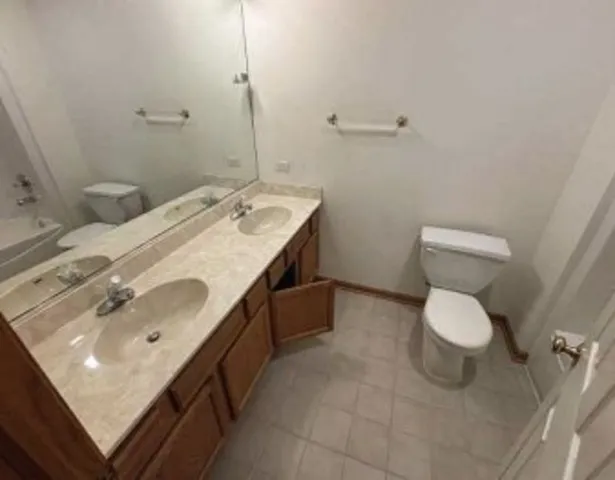 a white toilet sitting next to a bath tub