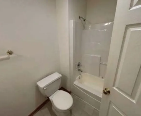 a view of staircase with wooden floor and white walls