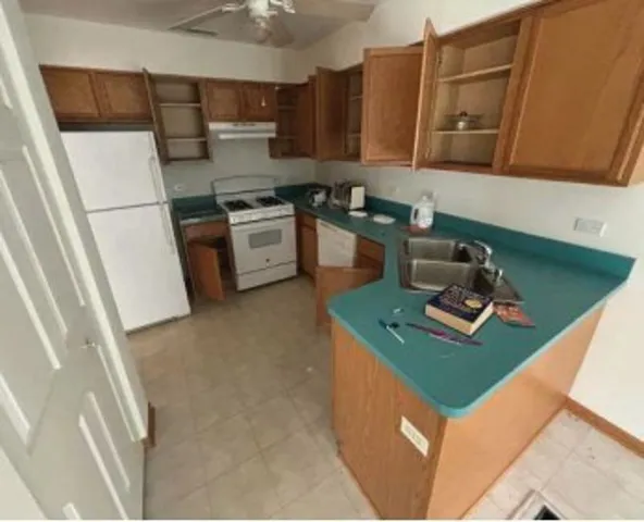 a kitchen with stainless steel appliances granite countertop a sink refrigerator and microwave