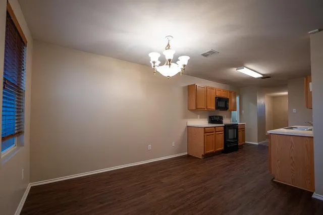 a view of a kitchen with a sink a stove and dishwasher