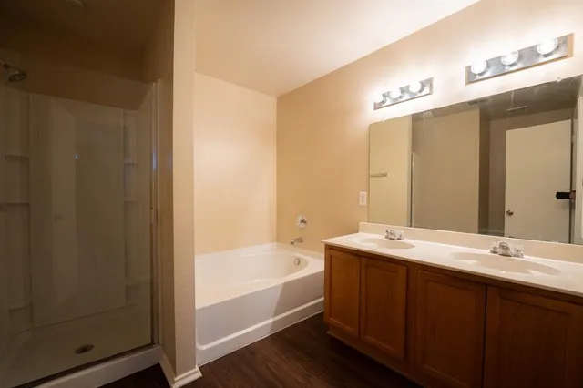a bathroom with a tub sink and mirror