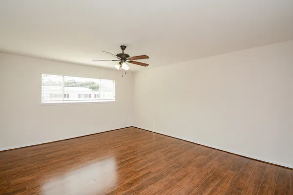 a view of a big room with wooden floor closet and windows