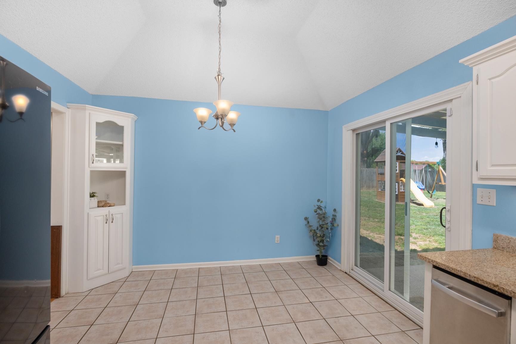 284 Pwr Loop Munford, TN 38058 - Photo 13 of 36 Unfurnished dining area featuring vaulted ceiling, hanging lights, and light tile patterned floors