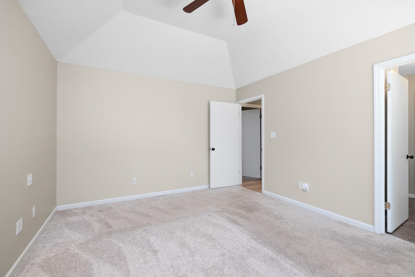 284 Pwr Loop Munford, TN 38058 - Photo 17 of 36 Unfurnished bedroom with light carpet, lofted ceiling, and ceiling fan