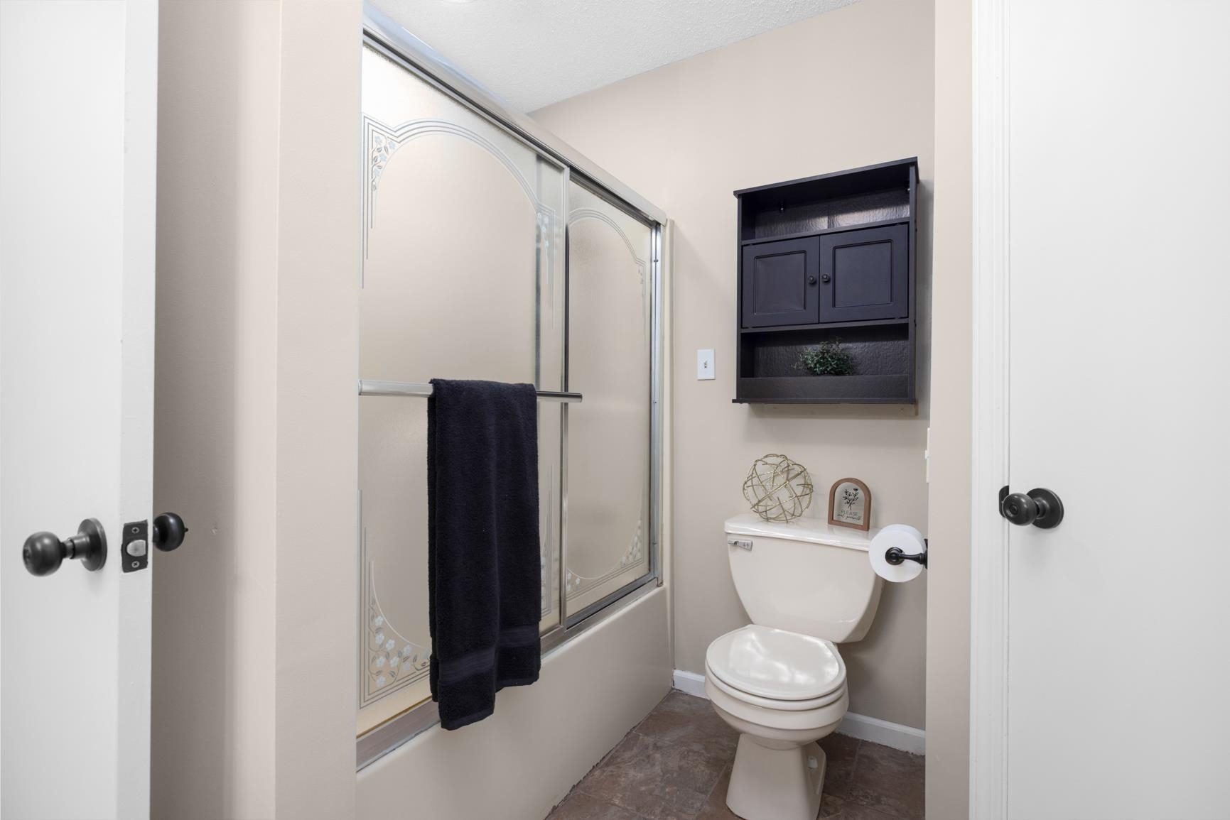 284 Pwr Loop Munford, TN 38058 - Photo 19 of 36 Full bathroom featuring toilet and bath / shower combo with glass door