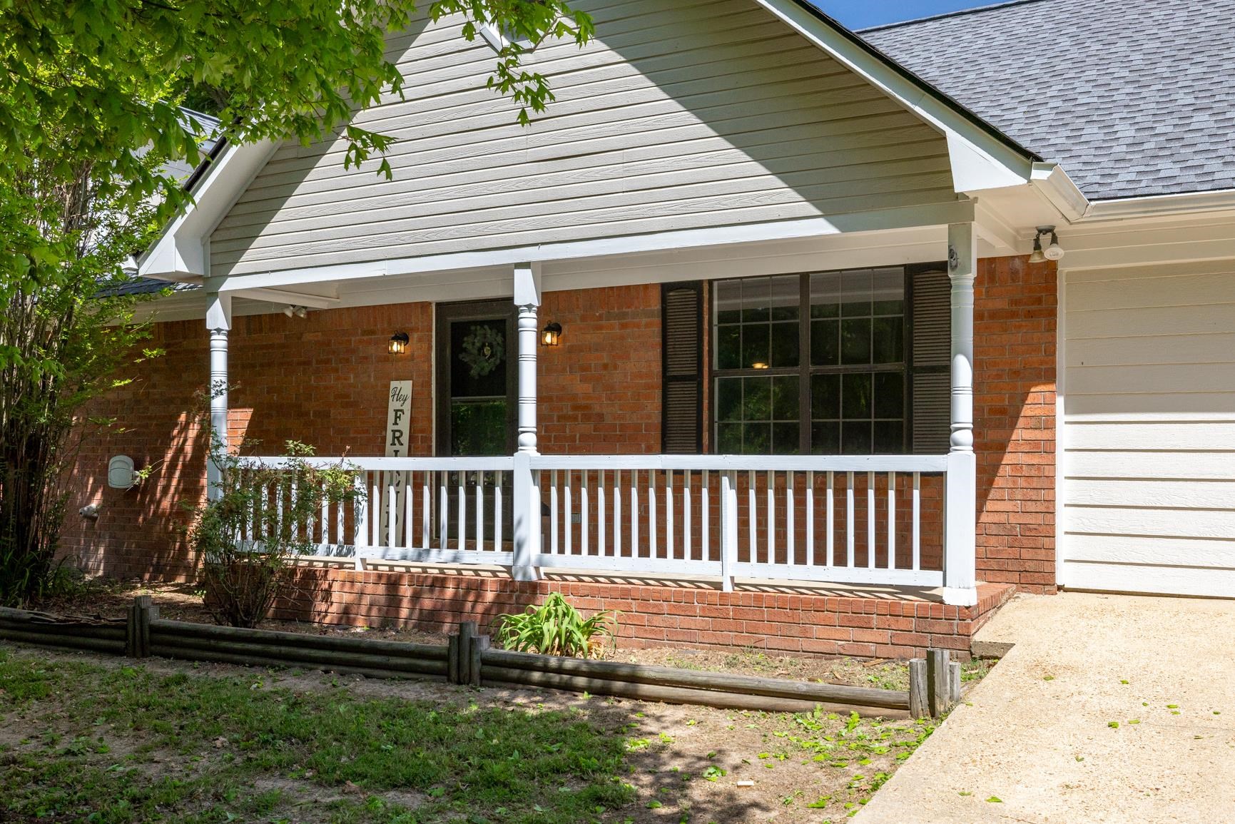 284 Pwr Loop Munford, TN 38058 - Photo 2 of 36 View of front of home with roof with shingles, brick siding, and a porch