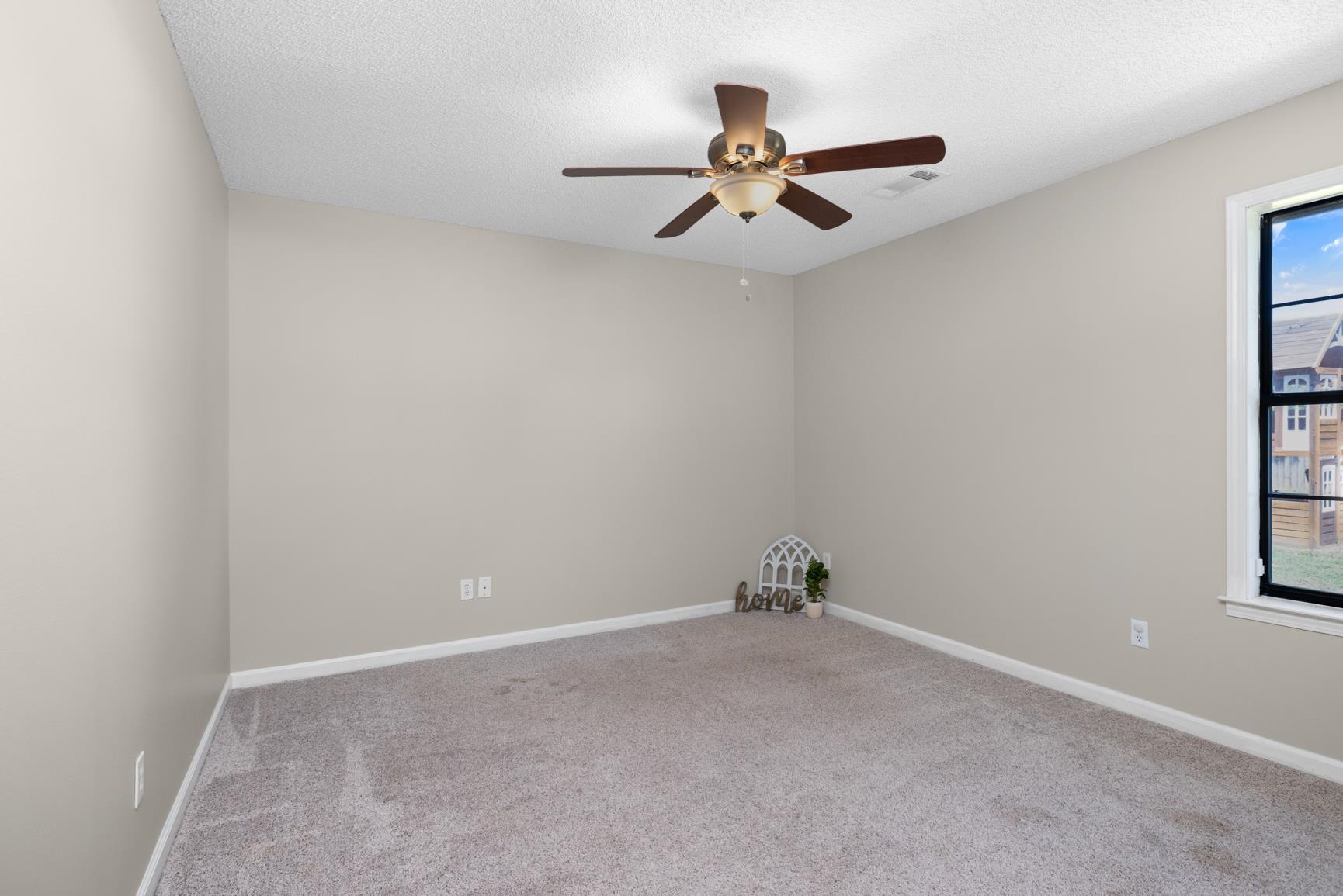 284 Pwr Loop Munford, TN 38058 - Photo 24 of 36 Empty room featuring ceiling fan, carpet, and a textured ceiling