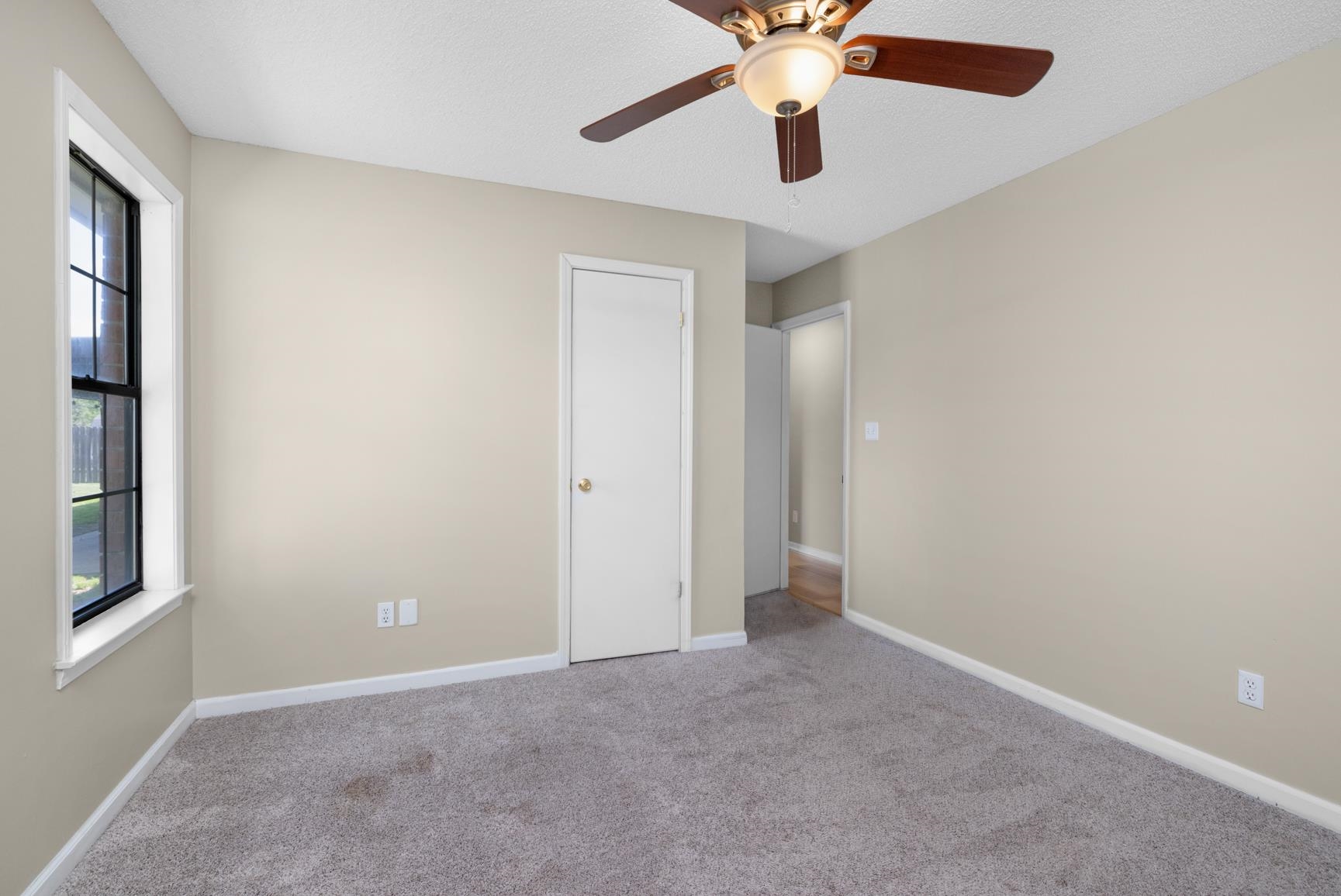 284 Pwr Loop Munford, TN 38058 - Photo 25 of 36 Unfurnished bedroom featuring light colored carpet and a ceiling fan
