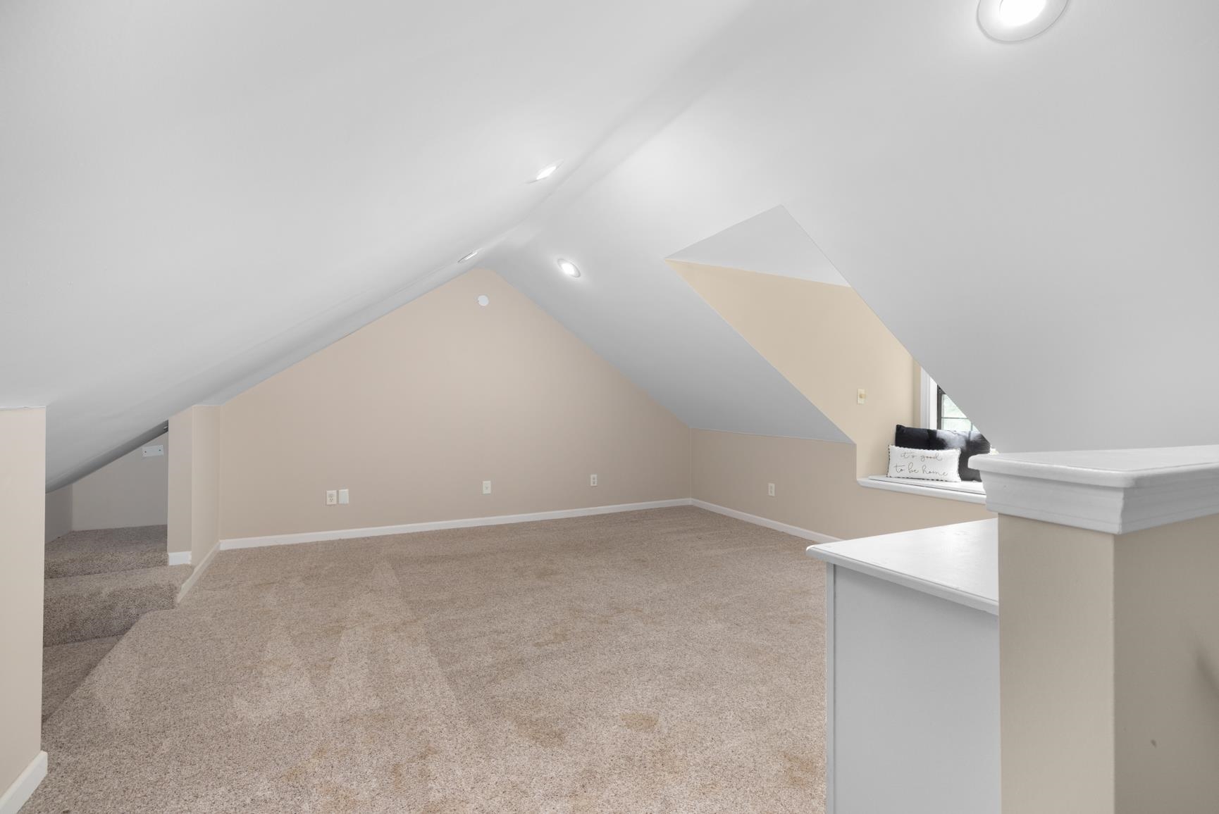 284 Pwr Loop Munford, TN 38058 - Photo 26 of 36 Additional living space featuring light carpet and vaulted ceiling