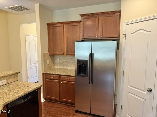 8227 Primanti Boulevard Raleigh, NC 27612 - Photo 10 of 25 a kitchen with a refrigerator and cabinets