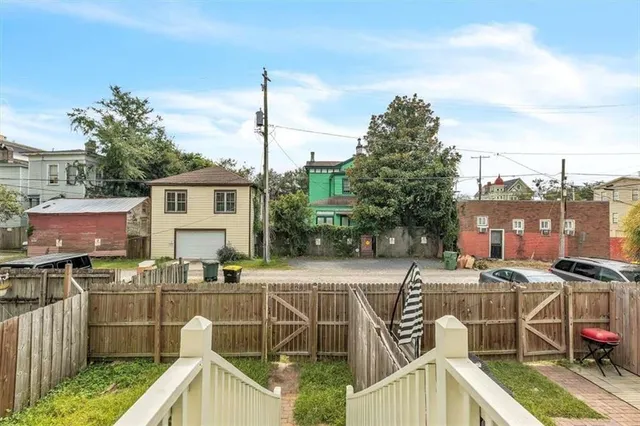a view of a patio with couches chairs potted plants and palm tree