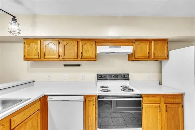 a kitchen with stainless steel appliances granite countertop a stove a sink and dishwasher