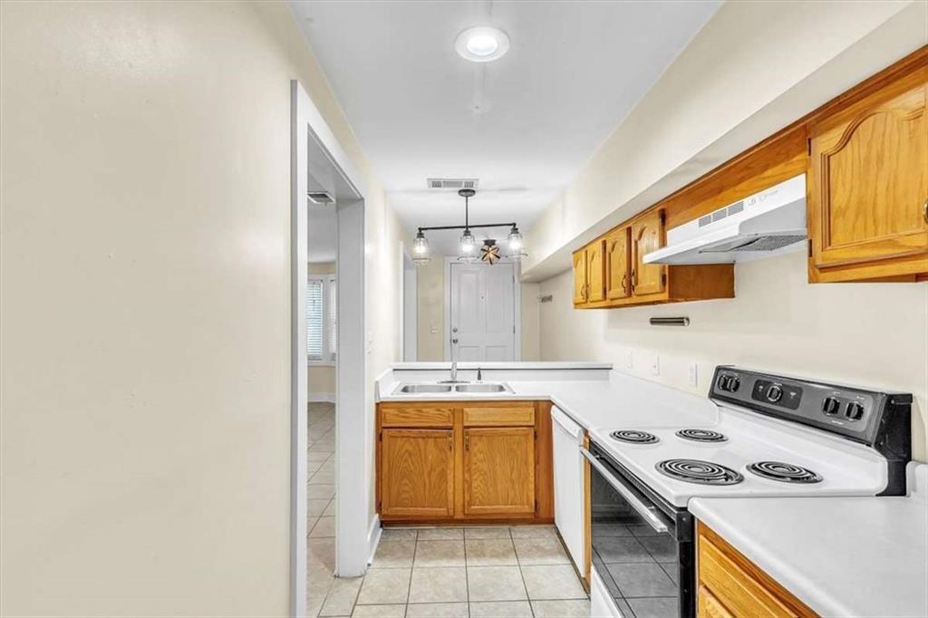 209 East Duffy Street, Unit A Savannah, GA 31401 - Photo 8 of 17 a kitchen with a stove a sink and a microwave