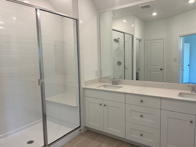 2139 Mosaic Vly Court Angleton, TX 77515 - Photo 11 of 14 a bathroom with a double vanity sink and mirror