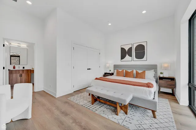 a bed room with a bed and a chair