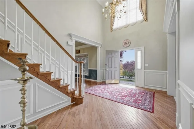 a view of a dining room with furniture wooden floor and chandelier