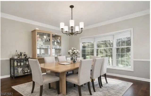 a view of a dining room and a kitchen with a table chairs