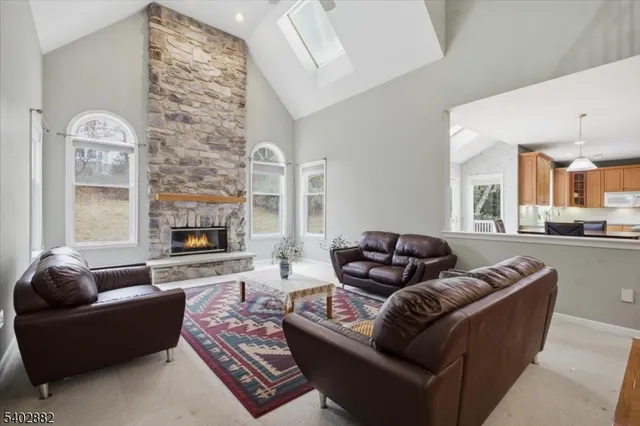 a kitchen with a sink a center island stainless steel appliances and cabinets