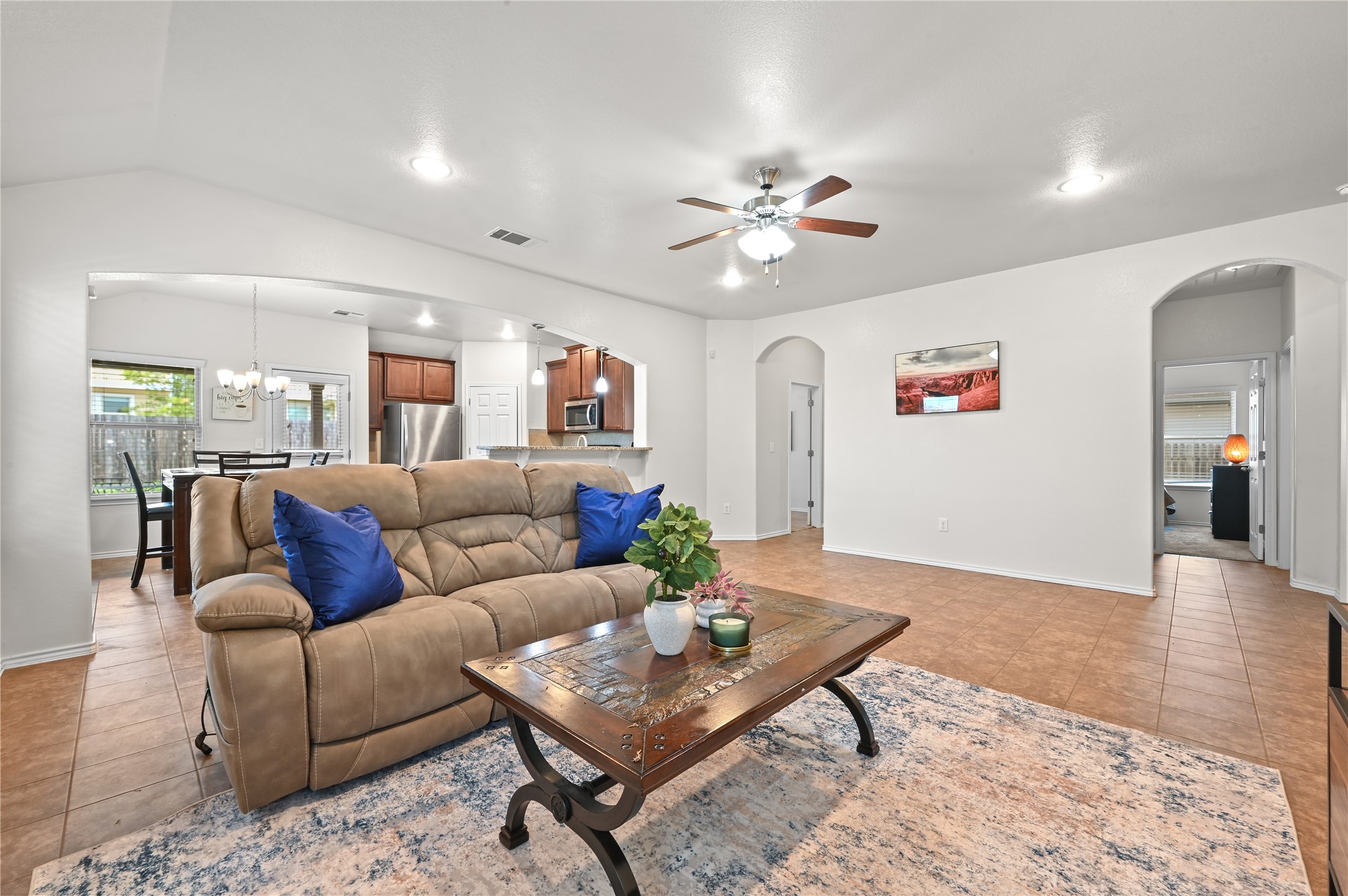 303 Limerick Road Buda, TX 78610 - Photo 4 of 23 Spacious living area featuring tile flooring, vaulted ceilings with recessed lighting, and a ceiling fan