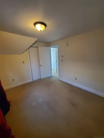 a view of room and hall with wooden floor