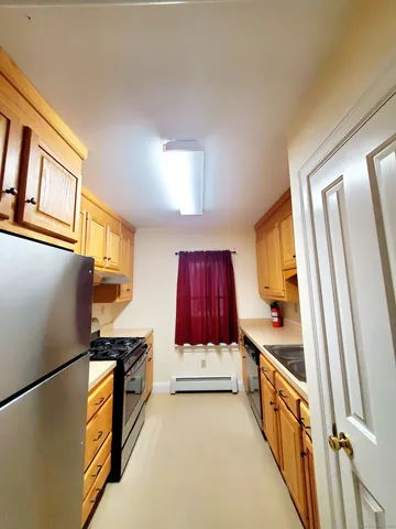 a kitchen with stainless steel appliances a refrigerator a stove a microwave and cabinets