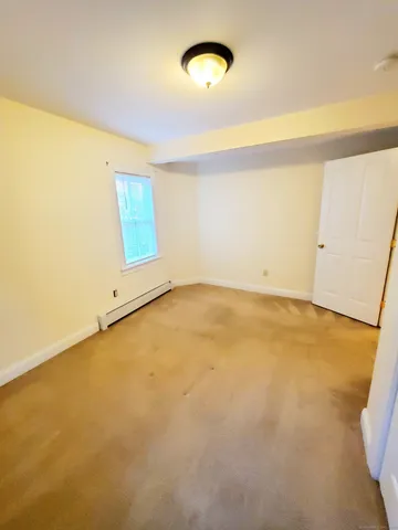 an empty room with a empty space and a window