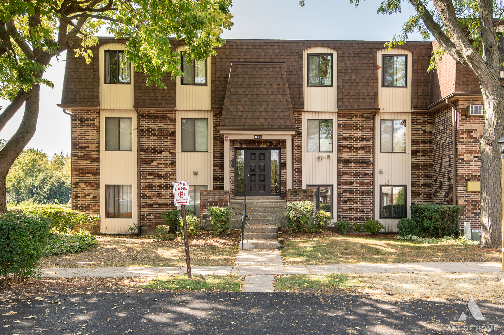 835 Waterview Circle, Unit 2 Vernon Hills, IL 60061 - Photo 1 of 30 a view of a brick house with many windows plants and large tree