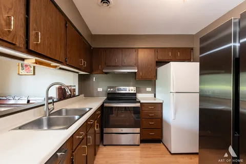 a kitchen with a refrigerator sink and stove