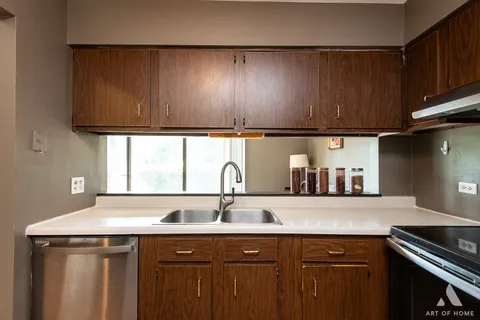 a kitchen with a sink and cabinets
