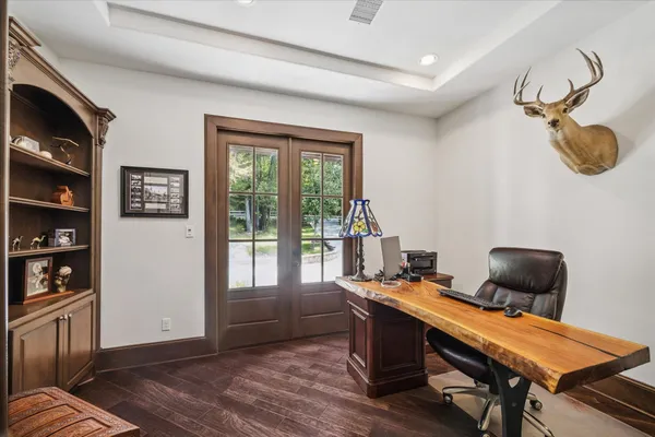 a view of a dining room with furniture and a chandelier