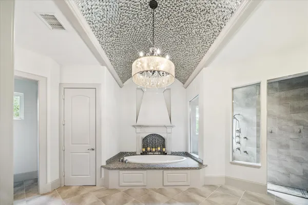 a bathroom with a granite countertop double vanity sink and a mirror