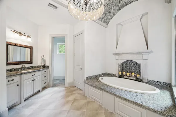 a kitchen with granite countertop white cabinets and a window