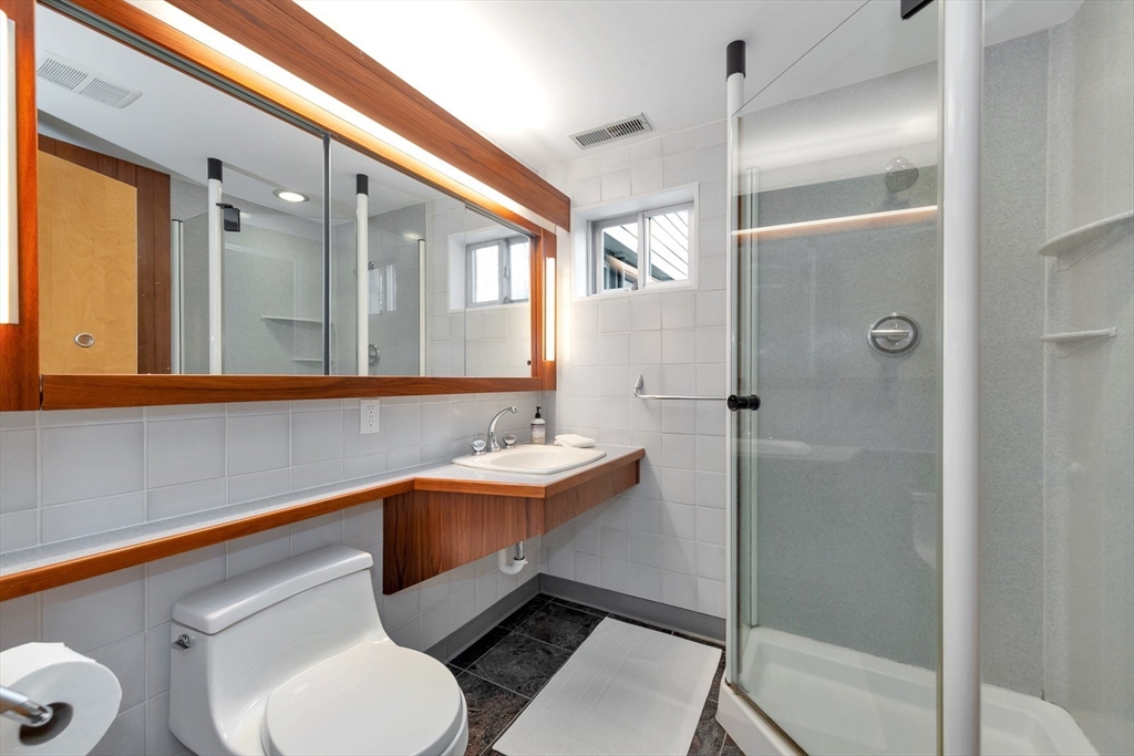 85 The Valley Road Concord, MA 01742 - Photo 26 of 38 a bathroom with a toilet sink shower and mirror