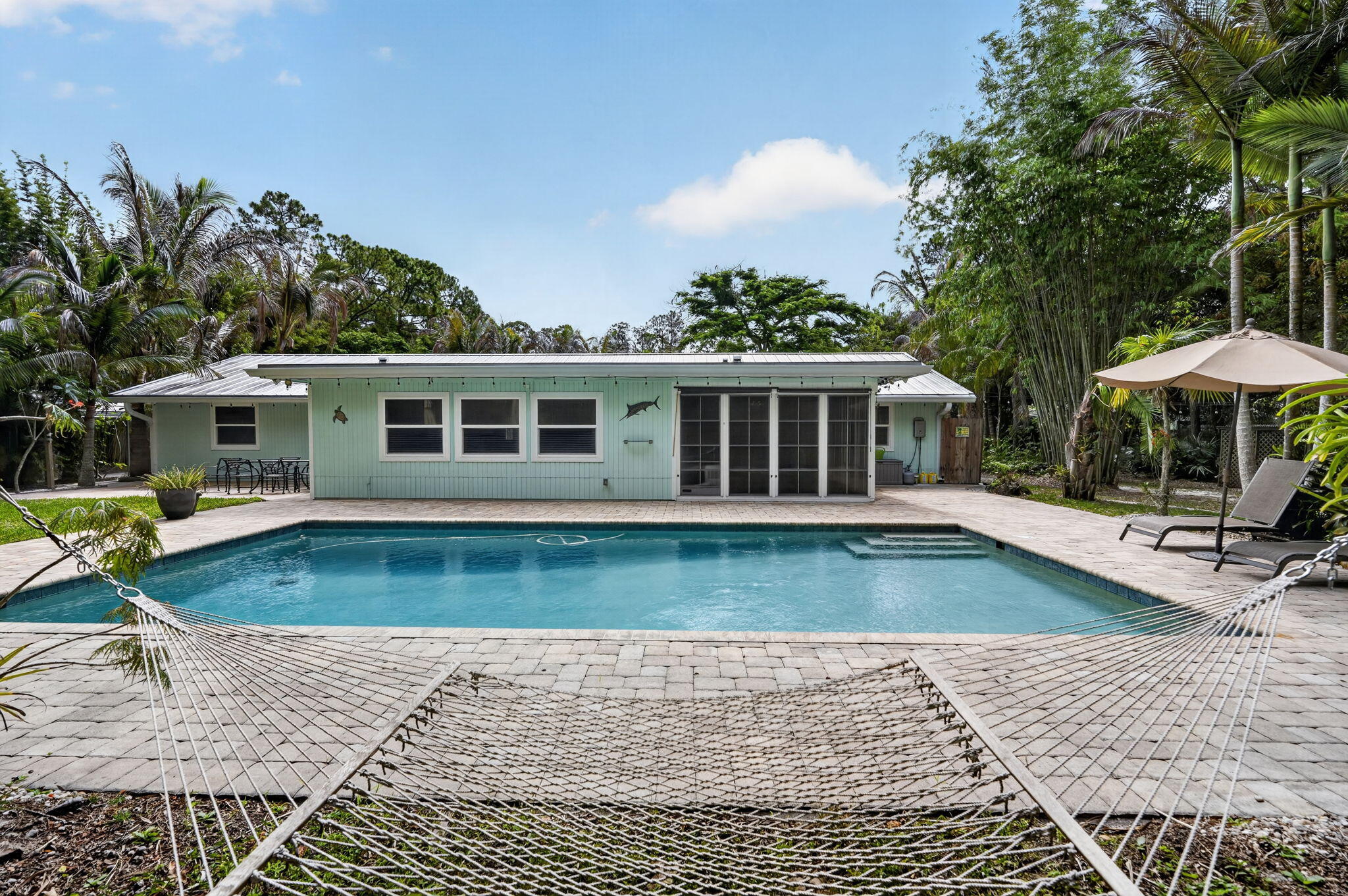 17391 Alexander Run Jupiter, FL 33478 - Photo 39 of 55 a view of a house with swimming pool and sitting area