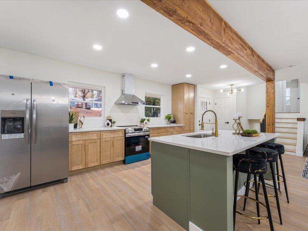 2874 Cocklebur Cove Court Decatur, GA 30034 - Photo 12 of 36 a kitchen with stainless steel appliances granite countertop a sink a stove a refrigerator and island with wooden floor